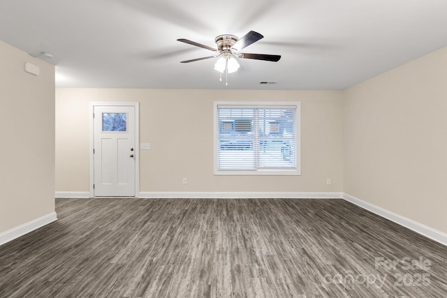 interior space with dark wood-style floors, visible vents, baseboards, and a ceiling fan