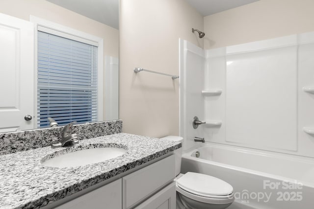 bathroom with shower / bathing tub combination, vanity, and toilet