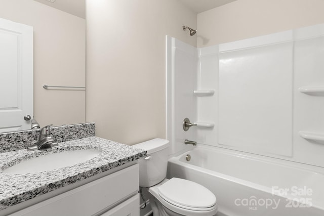 bathroom with washtub / shower combination, vanity, and toilet