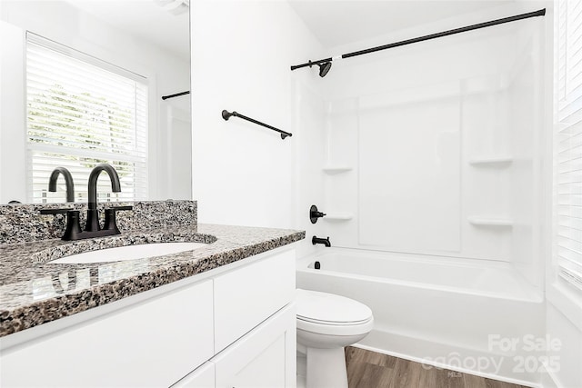 bathroom with shower / bath combination, vanity, toilet, and wood finished floors