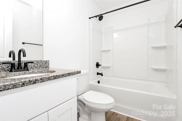 bathroom with shower / bath combination, vanity, toilet, and wood finished floors