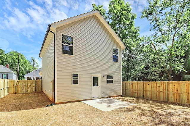 back of house with a patio, a gate, and a fenced backyard