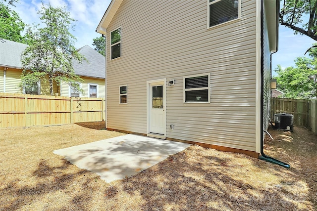 back of house featuring a patio, a fenced backyard, and central AC