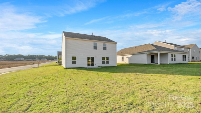 rear view of property featuring a yard