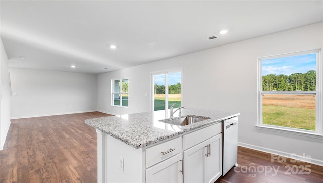 kitchen with sink, dishwasher, light stone countertops, a kitchen island with sink, and white cabinets