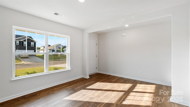 spare room featuring dark wood-type flooring