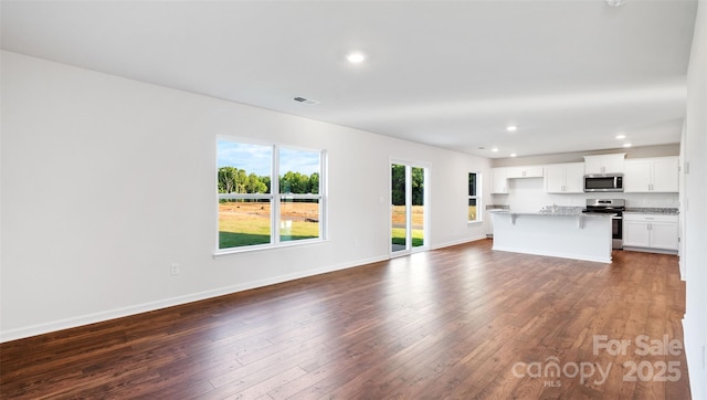 unfurnished living room featuring dark wood-type flooring