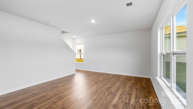 spare room featuring dark wood-type flooring