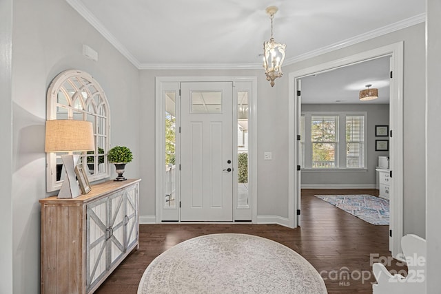 entryway with dark wood-type flooring, ornamental molding, and a notable chandelier