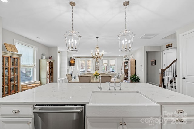 kitchen with white cabinetry, light stone counters, pendant lighting, and dishwasher