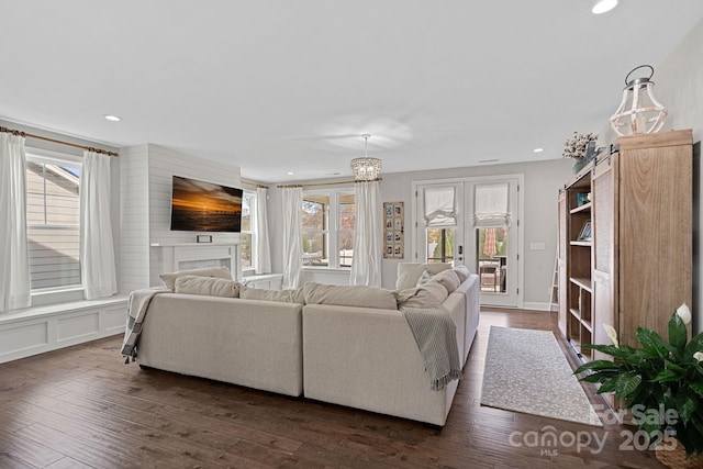 living room featuring french doors, dark hardwood / wood-style floors, and a wealth of natural light