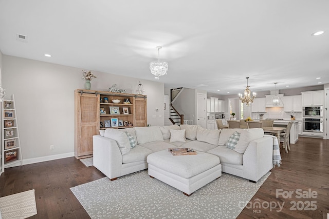 living room featuring dark hardwood / wood-style flooring and a chandelier