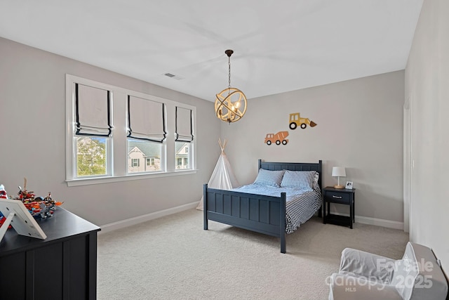 carpeted bedroom with a notable chandelier