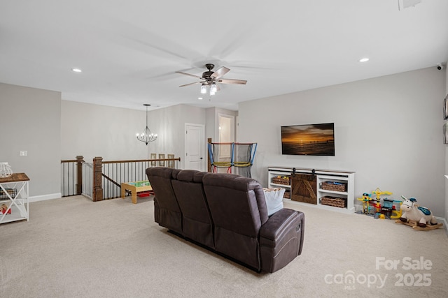 living room with carpet and ceiling fan with notable chandelier