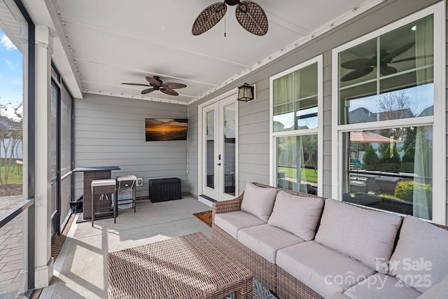 sunroom featuring ceiling fan