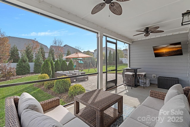 sunroom featuring ceiling fan