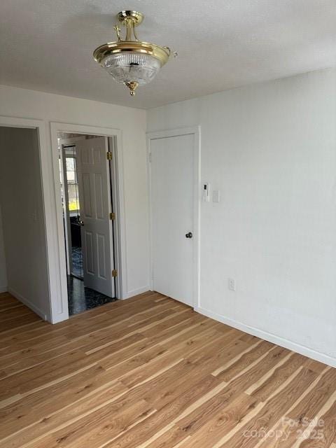 16 Castle St, Asheville, NC 28803 - spare room with baseboards and light wood-type flooring