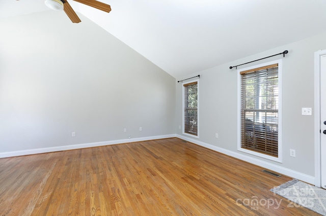 unfurnished room with ceiling fan, vaulted ceiling, and light hardwood / wood-style flooring