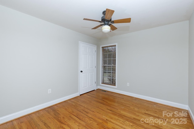 spare room with wood-type flooring and ceiling fan