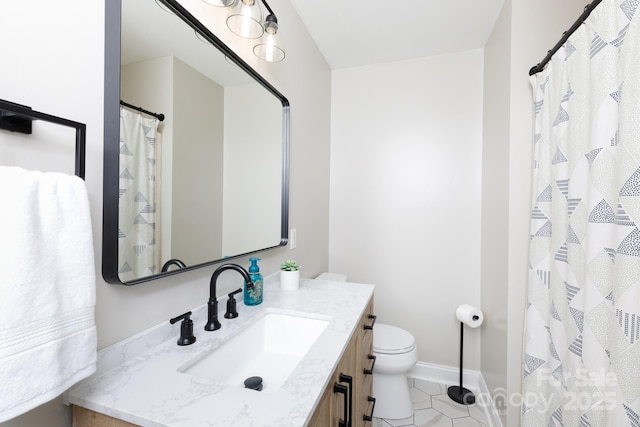 bathroom featuring vanity, tile patterned floors, and toilet