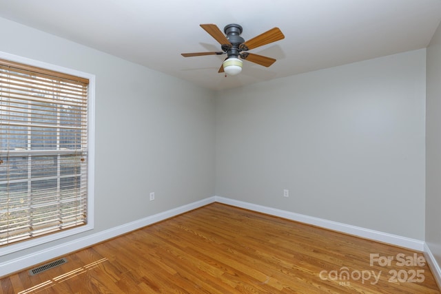 spare room featuring ceiling fan and hardwood / wood-style floors