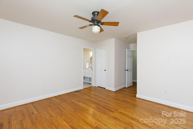 spare room with ceiling fan and light wood-type flooring