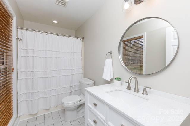 full bathroom featuring tile patterned floors, vanity, toilet, and shower / bath combo