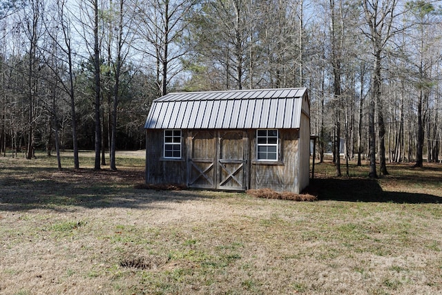 view of outdoor structure featuring a lawn