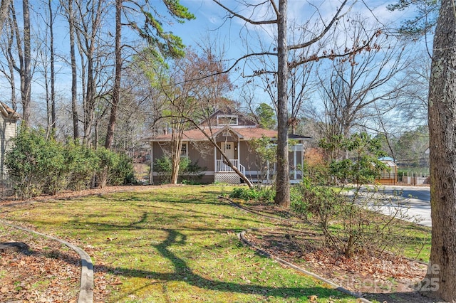 exterior space with covered porch and a front yard