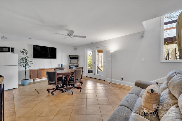 home office featuring baseboards, light tile patterned flooring, and a ceiling fan