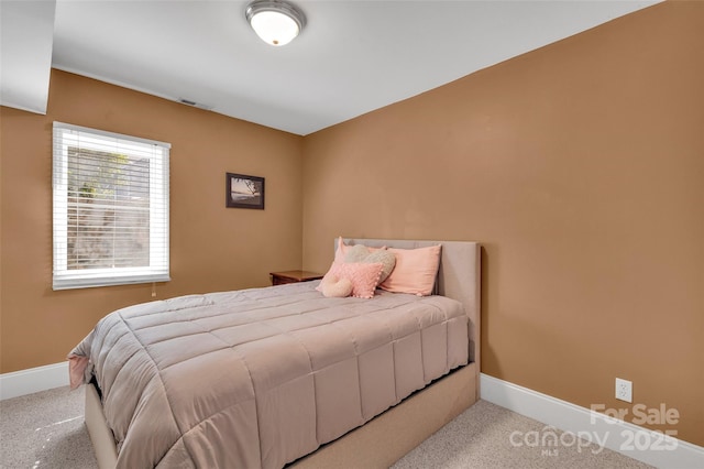 carpeted bedroom with baseboards and visible vents