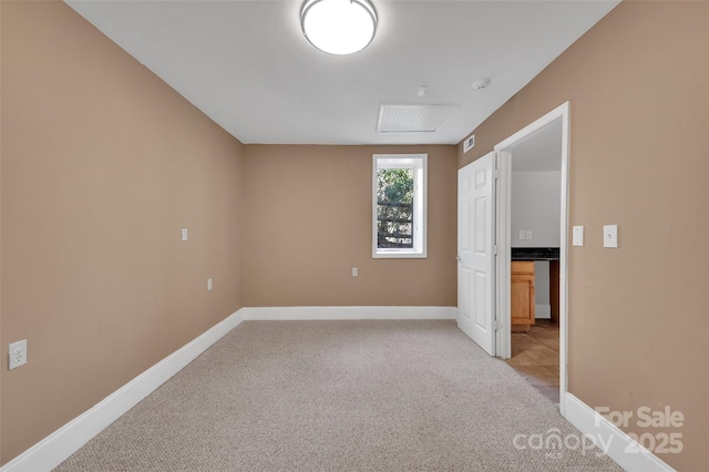 empty room featuring light carpet, visible vents, and baseboards