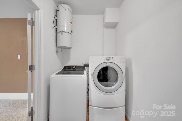 washroom featuring baseboards, carpet, and washing machine and clothes dryer