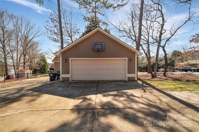 detached garage featuring fence