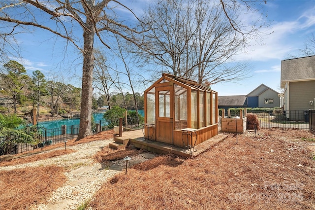 view of yard featuring an outbuilding, fence, and an exterior structure