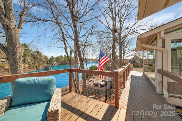 wooden deck featuring a water view