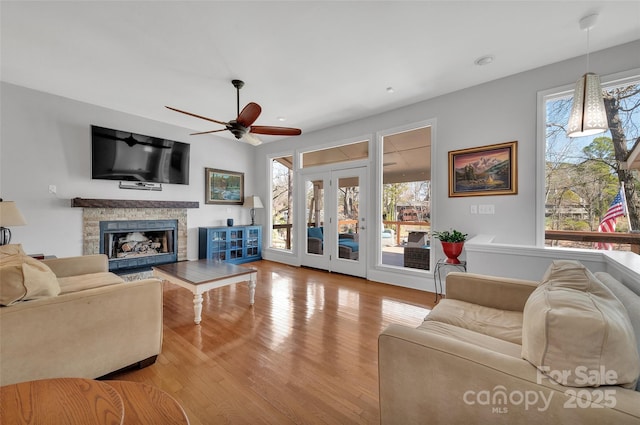 1077 Gauguin Ln, Tega Cay, SC 29708 - living room with wood finished floors, ceiling fan, plenty of natural light, a stone fireplace, and recessed lighting