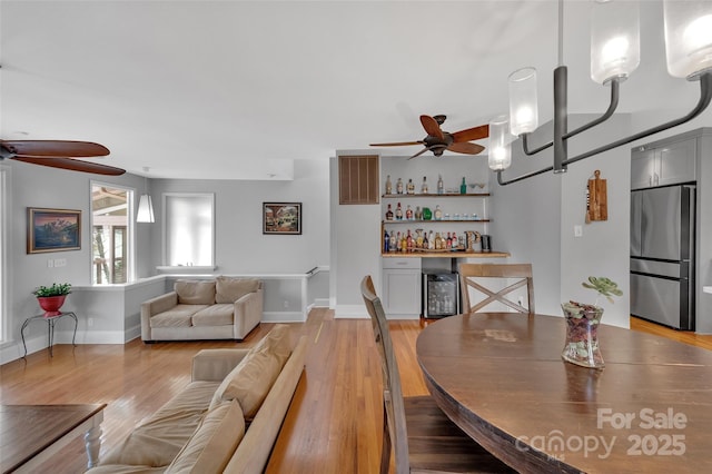 1077 Gauguin Ln, Tega Cay, SC 29708 - dining space featuring a ceiling fan, a dry bar, light wood finished floors, and baseboards