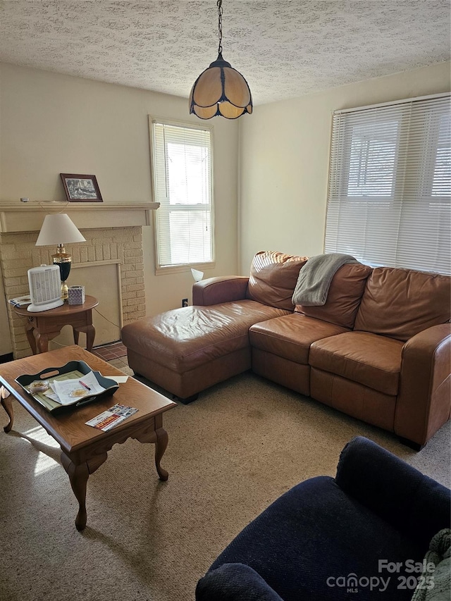 living room featuring a textured ceiling and a brick fireplace