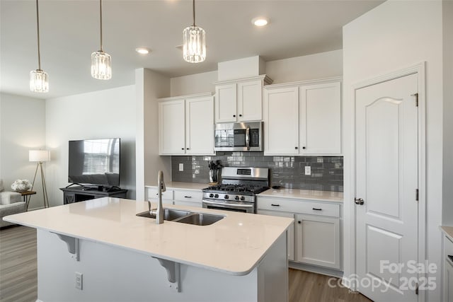 kitchen featuring stainless steel appliances, sink, and white cabinets