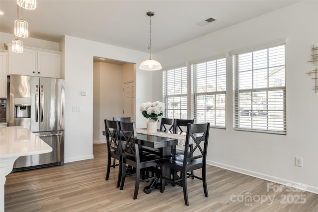 dining area with light hardwood / wood-style flooring