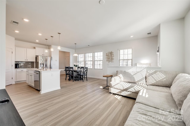 living room with light hardwood / wood-style floors