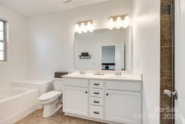 bathroom with vanity, toilet, tile patterned flooring, and a tub