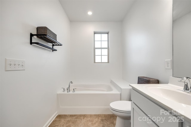 bathroom featuring tile patterned floors, vanity, toilet, and a washtub