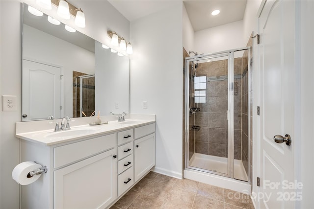 bathroom featuring tile patterned flooring, vanity, and walk in shower