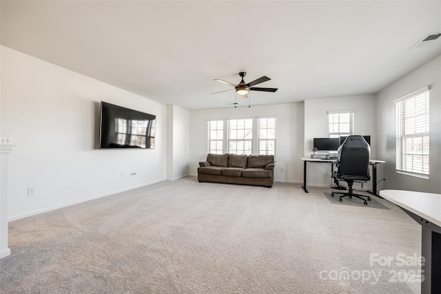 carpeted office space featuring ceiling fan