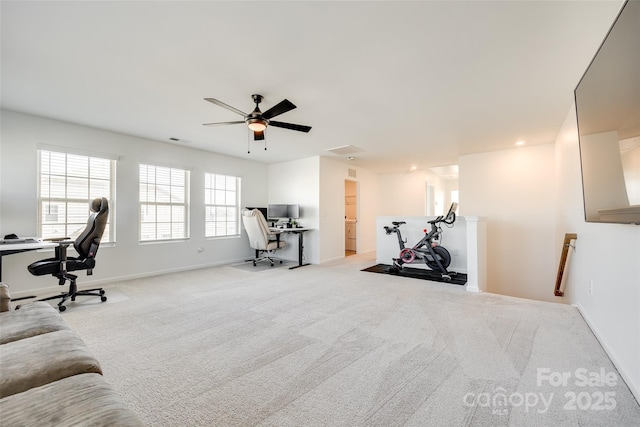 exercise room featuring ceiling fan and light colored carpet