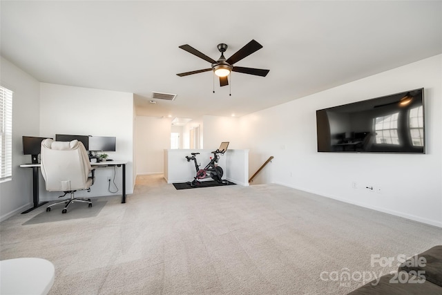 home office featuring ceiling fan and light carpet