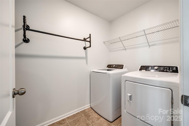 washroom with light tile patterned flooring and washer and clothes dryer