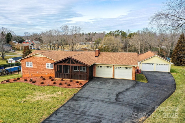 ranch-style home featuring a garage and a front lawn